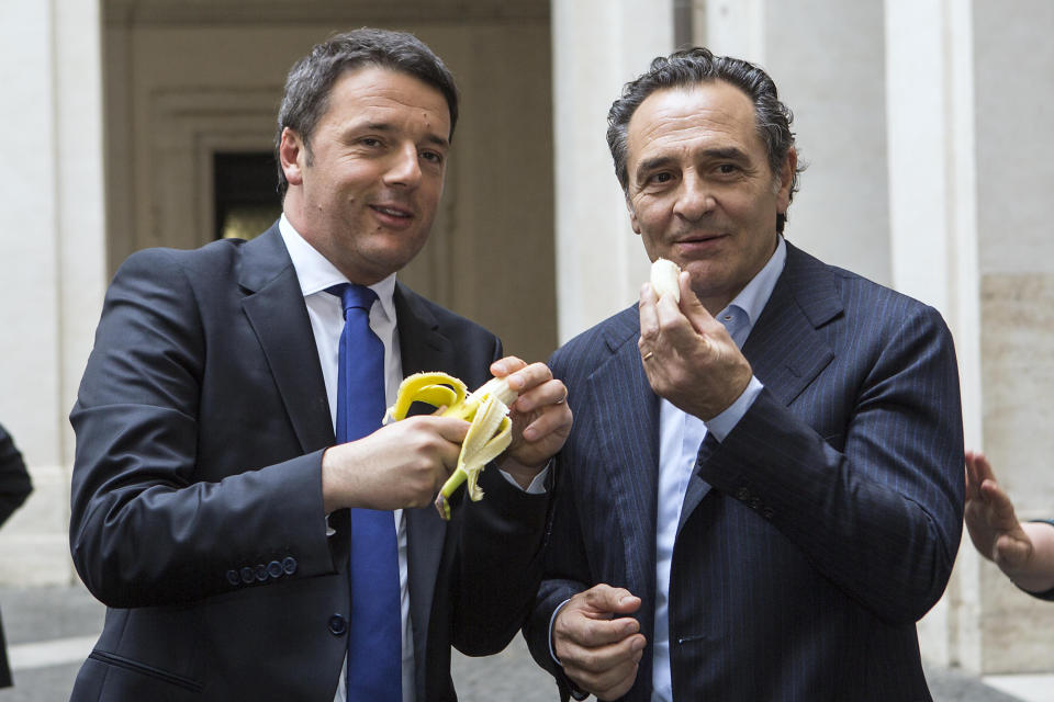 Italian premier Matteo Renzi, left, and Italian national soccer team coach Cesare Prandelli share a banana in solidarity to Barcelona Brazilian player Dani Alves, during a ceremony in Rome, Monday, April 28, 2014. Alves, who is black, was about to take a corner in Sunday's 3-2 win at Villarreal's El Madrigal Stadium when a banana landed on the pitch in front of him. The Brazil international picked it up, peeled it and ate some of it before throwing the rest aside. After the match, Alves said humor was the best way to combat racism in sport. That sentiment has led fellow football players, officials and even political figures from around the globe to respond with solidarity by picturing themselves eating a banana. (AP Photo/Roberto Monaldo, Lapresse) ITALY OUT