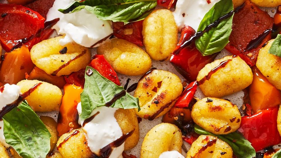 sheet pan roasted gnocchi and peppers topped with burrata, basil and balsamic reduction