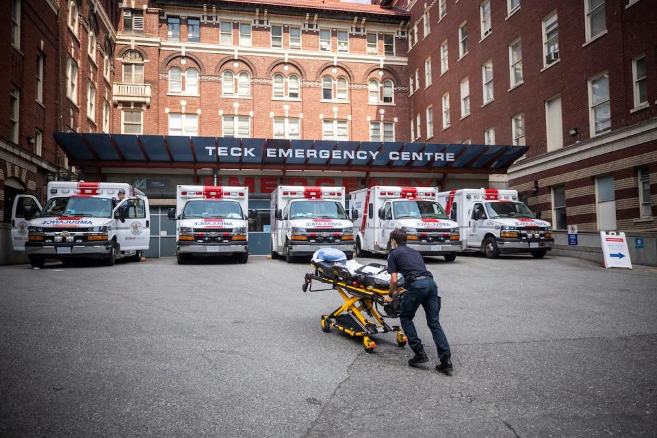 A B.C. Ambulance Service paramedic is pictured outside of St. Paul’s Hospital in Vancouver, British Columbia on Wednesday, June 30, 2021. 