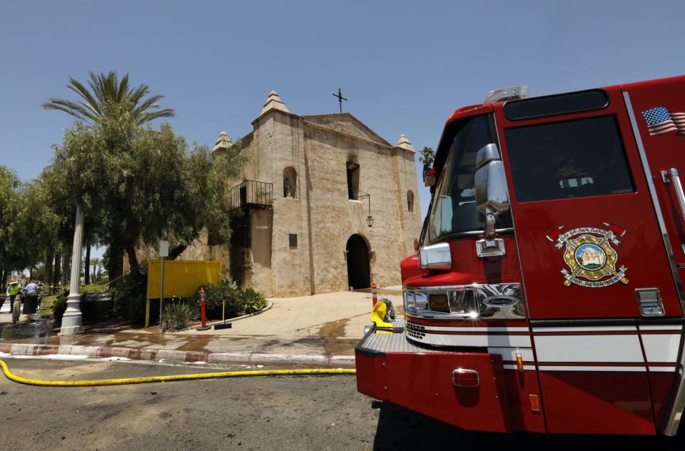 A fire truck sits outside the historic San Gabriel Mission on a sunny day