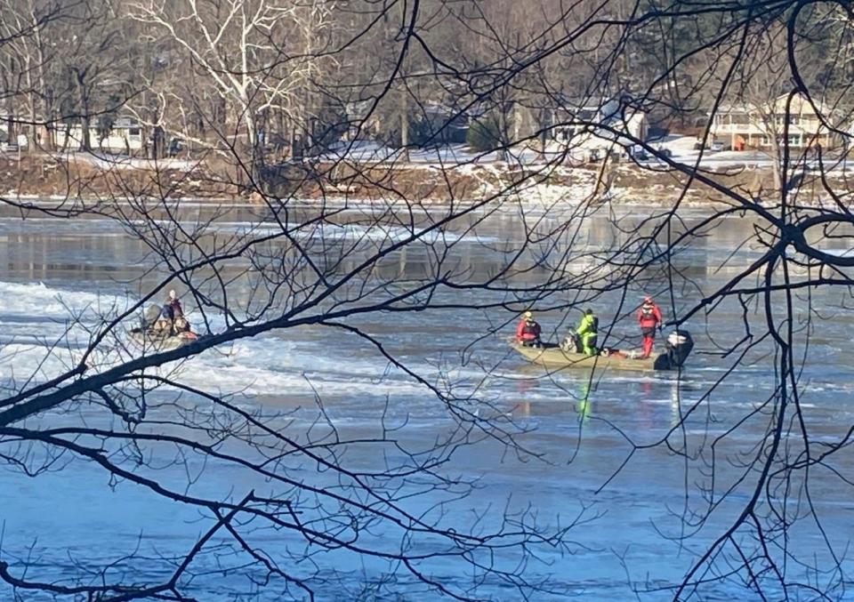 Three duck hunters, left, became stranded in a disabled boat on the Potomac River on Saturday morning with temperatures in the single digits. One of the rescue boats, right, approaching them as it works its way through some ice.