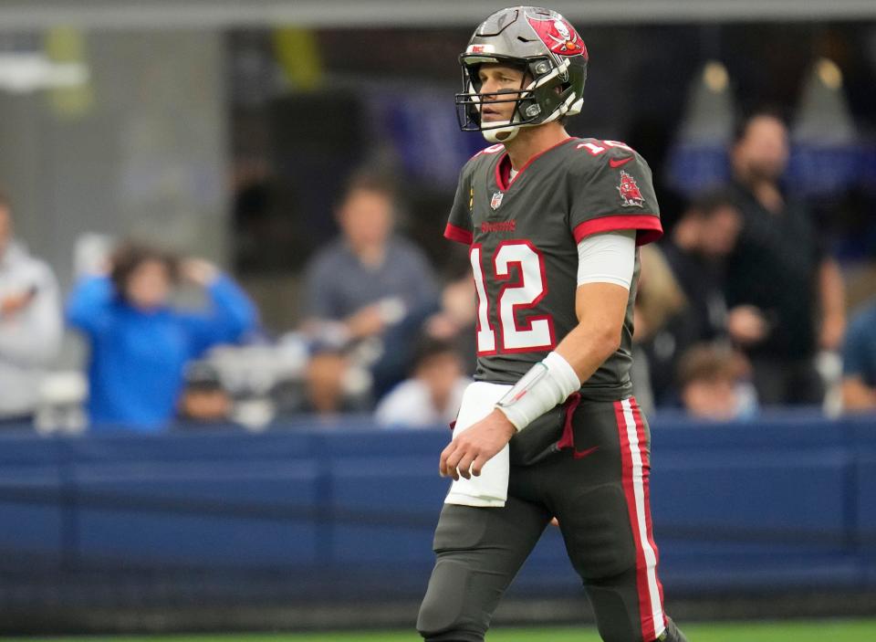 Tampa Bay Buccaneers quarterback Tom Brady (12) walks to the bench during a timeout in the second quarter against the Los Angeles Rams at SoFi Stadium.