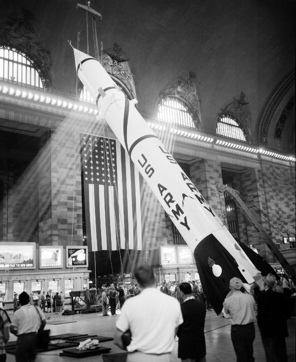 FILE - In this file photo of July 7, 1957, a 63-foot Redstone missile is hoisted into position for display in New York's Grand Central Terminal. To this day, there is a hole in the ceiling near a gold-leaf depiction of the constellation of Pisces that marks the spot where cables secured the rocket ship for dislplay. (AP Photo/Hans von Nolde, File)