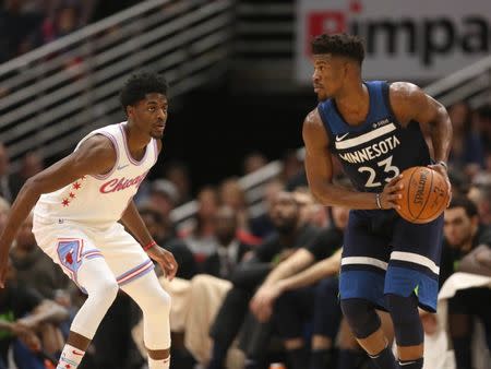 Feb 9, 2018; Chicago, IL, USA; Minnesota Timberwolves guard Jimmy Butler (23) is defended by Chicago Bulls guard Justin Holiday (7) during the first half at the United Center. Mandatory Credit: Dennis Wierzbicki-USA TODAY Sports