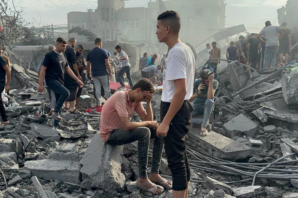 Palestinians look for survivors following an Israeli airstrike in Nusseirat refugee camp, Gaza Strip, Tuesday, Oct. 31, 2023.