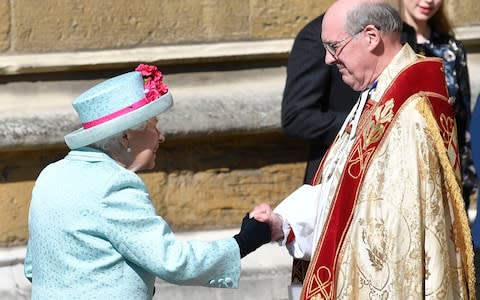 The Queen is welcomed to church by The Dean of Windsor, David Conner - Credit: Rex