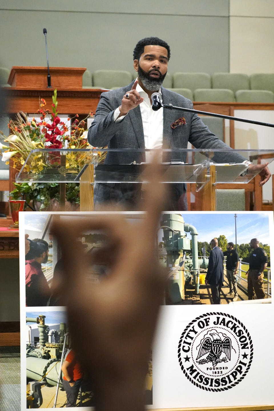 Mayor Chokwe Antar Lumumba responds to a question, Tuesday, Sept. 13, 2022, during a community meeting at College Hill Missionary Baptist Church, in Jackson, Miss. It was held to update the public on the current water system situation. (AP Photo/Rogelio V. Solis)