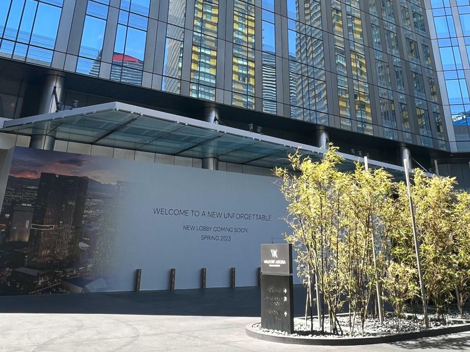 The exterior of a tall building with a sign indicating a new lobby is coming in 2023.