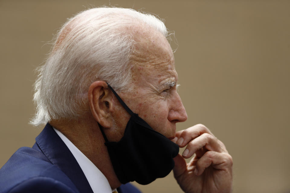 Democratic presidential candidate, former Vice President Joe Biden adjusts his mask while meeting with small business owners, Wednesday, June 17, 2020, at Carlette's Hideaway, a soul food restaurant, in Yeadon, Pa. (AP Photo/Matt Slocum)