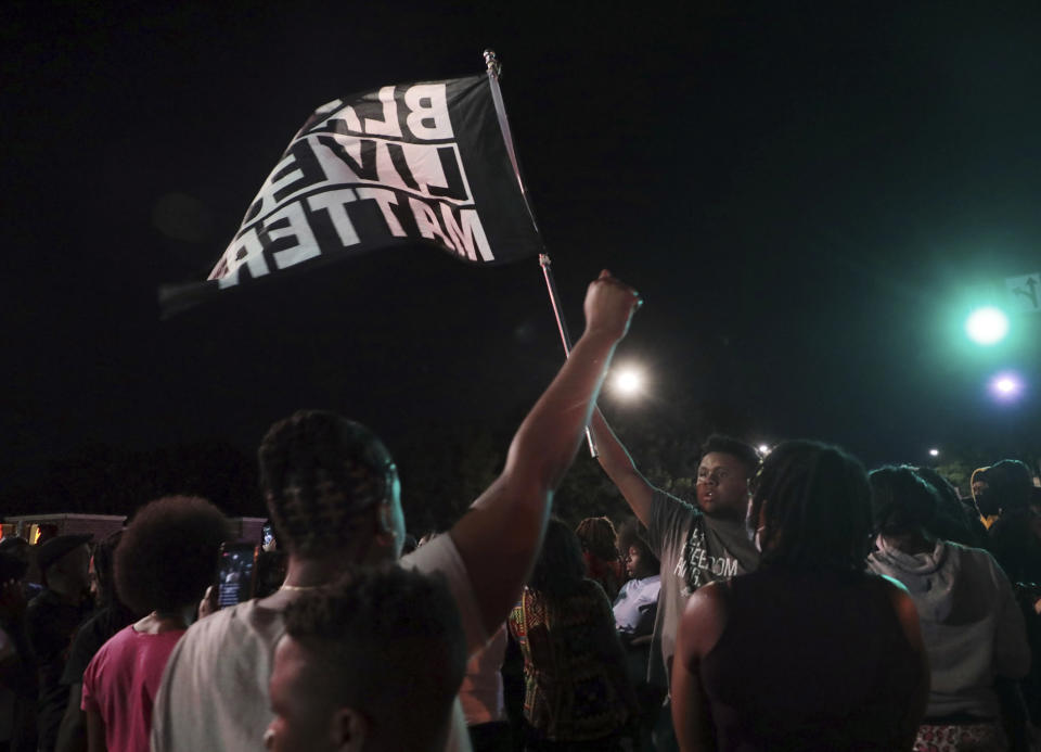 People demonstrate Thursday, June 24, 2021 in downtown Rock Hill, S.C. Demonstrators converged outside a South Carolina police station for a second day Thursday, protesting the arrest of two men by officers in Rock Hill who were recorded on a Facebook video wrestling and throwing punches with the two. (Tracy Kimball/The Charlotte Observer via AP)