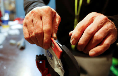 Heinz Haemmerle, or "Magic Heinzi" as US skier Lindsey Vonn calls her Austrian-born ski technician, sharpens the edges on a pair of skis of the world's most successful skiing women in his tiny waxing container at the Winter Olympics 2018 in Pyeongchang, South Korea February 19, 2018. Picture taken February 19, 2018. REUTERS/Leonhard Foeger