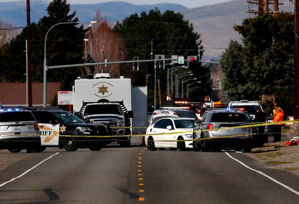 Investigators from the the Regional Special Investigations Unit document the officer involved shooting scene on March 24 on Argent Road at Road 64 in Pasco. A Benton County Sheriff deputy was involved in a shooting of the suspect that earlier shot and wounded a Pasco police officer at a gas station of West Court Street, according to a police press release.