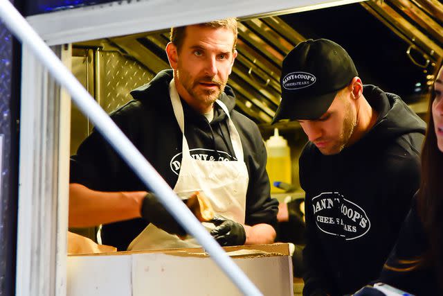 <p>Raymond Hall/GC Images</p> Bradley Cooper making cheesesteaks