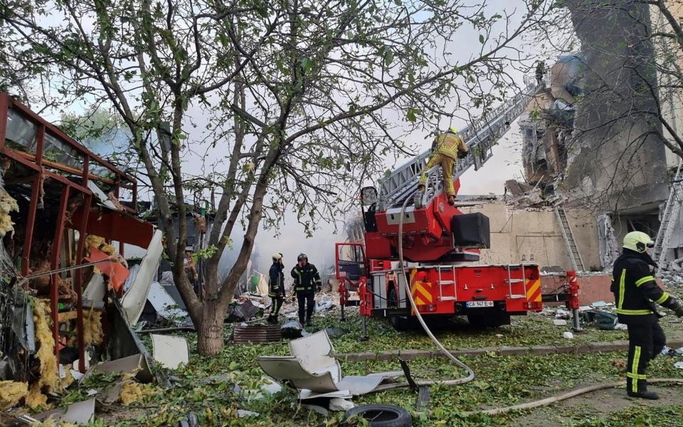 Emergency services work to extinguish a fire following a Russian attack in Cherkasy