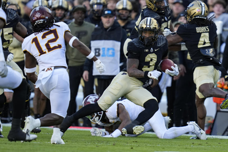 Purdue running back Tyrone Tracy Jr. (3) cuts away from Minnesota defensive back Darius Green (12) during the first half of an NCAA college football game in West Lafayette, Ind., Saturday, Nov. 11, 2023. (AP Photo/Michael Conroy)