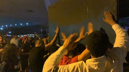 Small groups of protesters bang their hands on hoardings as they gather in central Cairo shouting anti-government slogans in Cairo