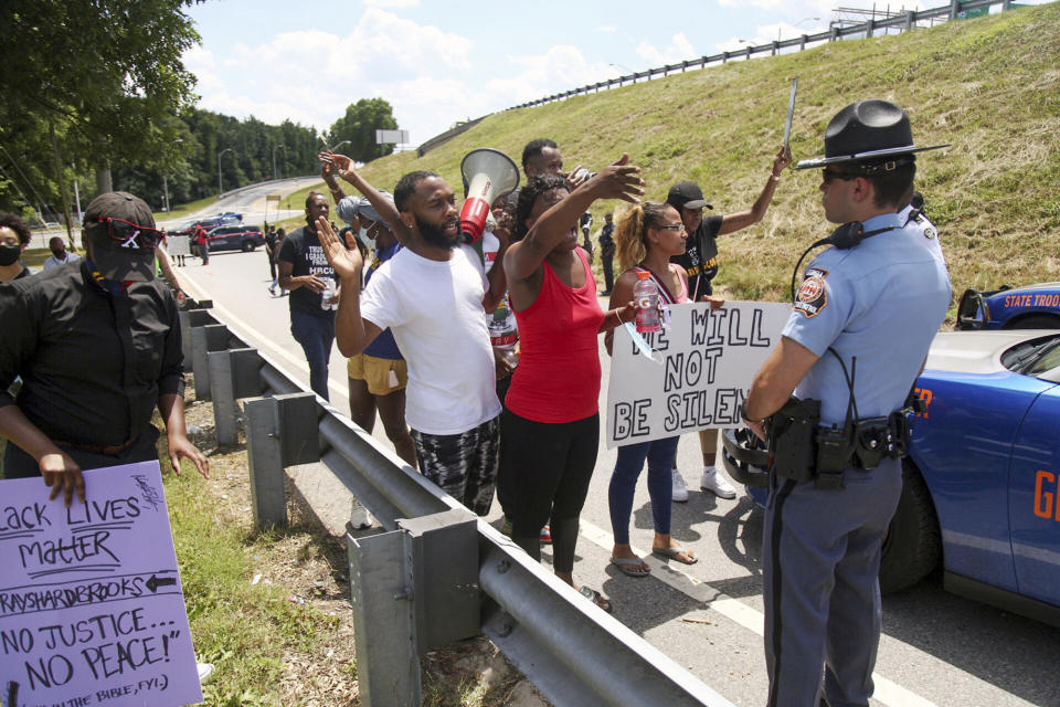 Protestors gather on University Ave near a Wendy's restaurant, Saturday, June 13, 2020 in Atlanta. Georgia authorities said Saturday a man was shot and killed in a late night struggle with Atlanta police outside a fast food restaurant after he failed a field sobriety test and resisted arrest. (Steve Schaefer/Atlanta Journal-Constitution via AP)
