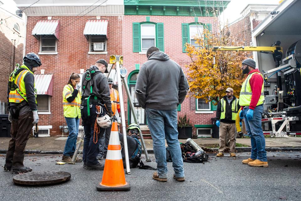 City officials inspect an underground sewer gas leak on N Monroe Street in Wilmington, Thursday, Dec. 8, 2022.