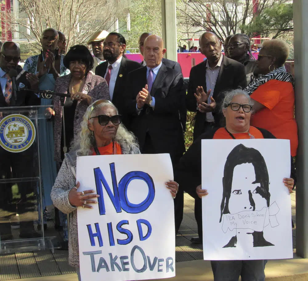 People hold up signs at a news conference on Friday, March 3, 2023, in Houston while protesting the proposed takeover of the city’s school district by the Texas Education Agency. (Juan A. Lozano/AP Photo)