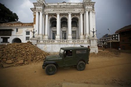 A Nepalese army vehicle drives past rubble at Bashantapur Durbar Square, a UNESCO world heritage site, after the April 25 earthquake in Kathmandu May 7, 2015. REUTERS/Navesh Chitrakar