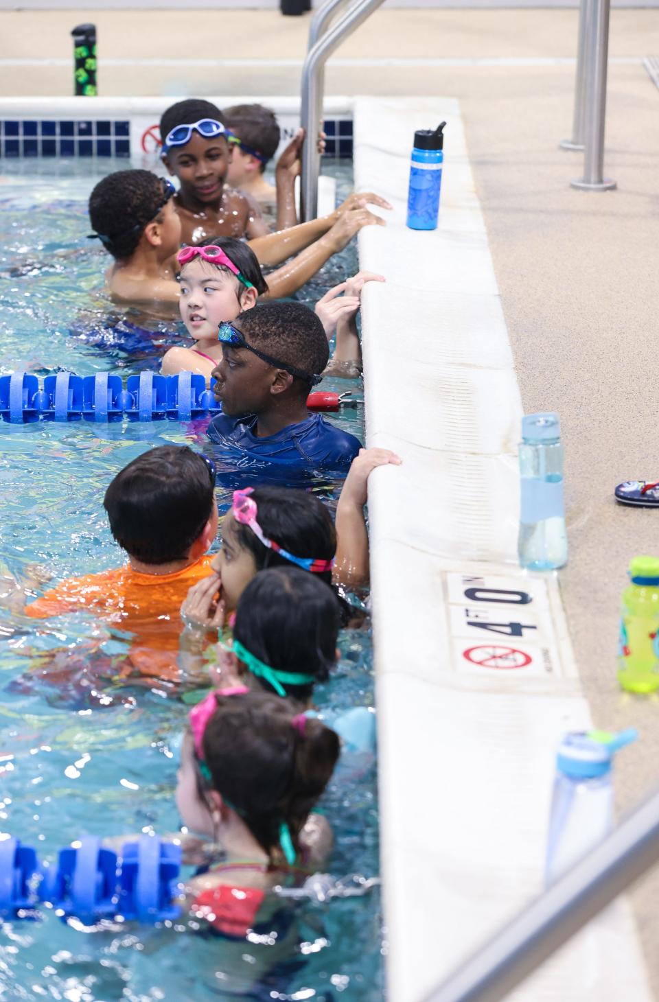 Students wait for Olympic swimmers Ryan Murphy and Cullen Jones at Goldfish Swim School in Milford, Dec. 2, 2023.