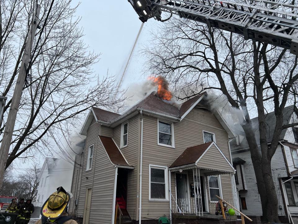 Canton firefighters withdrew from a burning four-unit apartment building on Seventh Street NW Wednesday afternoon after the structure's roof partially collapsed, the fire department said.