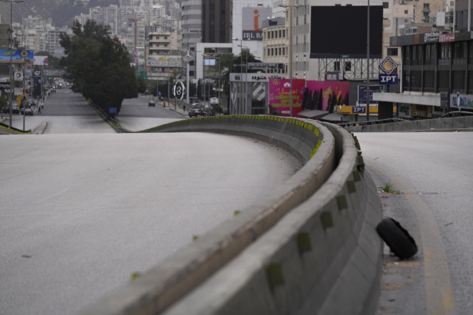 A highway blocked by protesters, sits empty during a general strike by public transport and labor unions to protest the country's deteriorating economic and financial conditions in Beirut, Lebanon, Thursday, Jan. 13, 2022. Protesters closed the country's major highways as well as roads inside cities and towns starting 5 a.m. making it difficult for people to move around. (AP Photo/Hussein Malla)