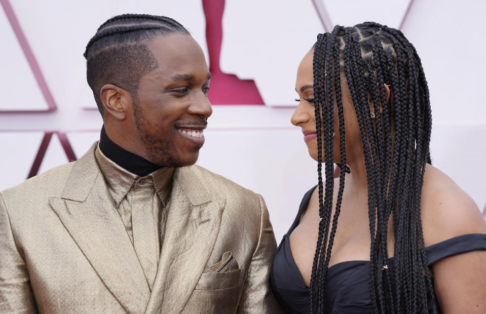 Leslie Odom Jr., left, and Nicolette Robinson arrive at the Oscars on Sunday, April 25, 2021, at Union Station in Los Angeles. (AP Photo/Chris Pizzello, Pool)