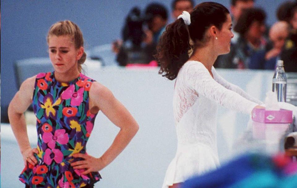 US figure skaters Tonya Harding (L) and Nancy Kerrigan avoid each other during a training session 17 February in Hamar, Norway, during the Winter Olympics. Kerrigan was hit on the knee in January 1994 during the US Olympic Trials and it was later learned that Harding's ex-husband and bodyguard masterminded the attack in hopes of improving Harding's chances at the US Trials and the Olympics.