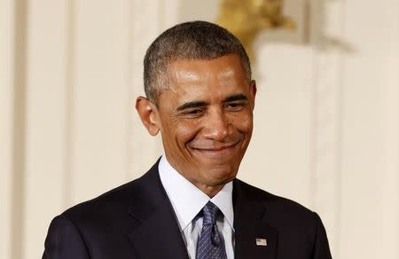 U.S. President Barack Obama smiles after he awards two Medals of Honor for actions during the Vietnam War while in the East Room of the White House in Washington, September 15, 2014. REUTERS/Larry Downing