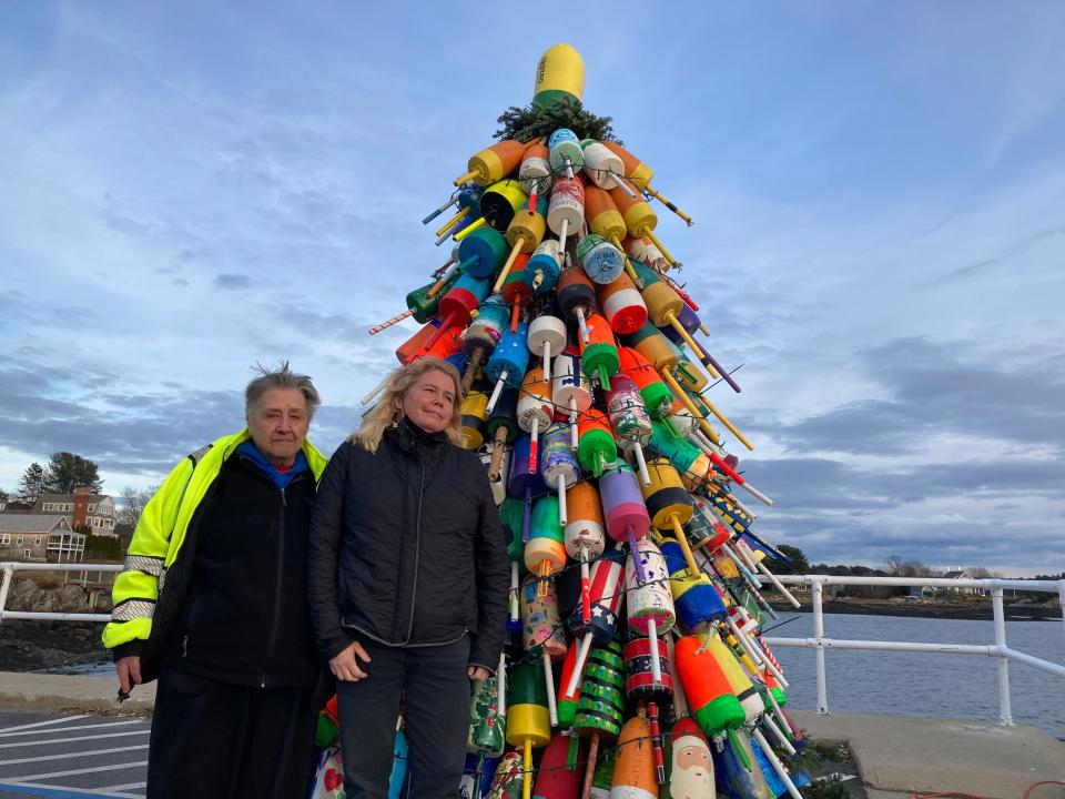 Sheila Chapman, left, and Kelly Philbrook, Kittery residents, seen Tuesday, Dec. 1, 2021, organized the town's first holiday lobster buoy tree to benefit Wreath Across America fundraising efforts.