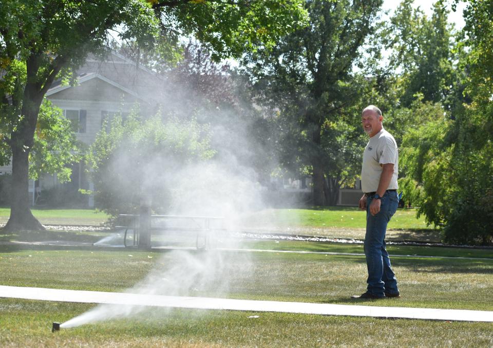 Andy Workman, an irrigation technician with Evergreen Landscape & Sprinkler, checks sprinkler heads while blowing out a commercial irrigation system in Fort Collins on Sept. 29, 2021.