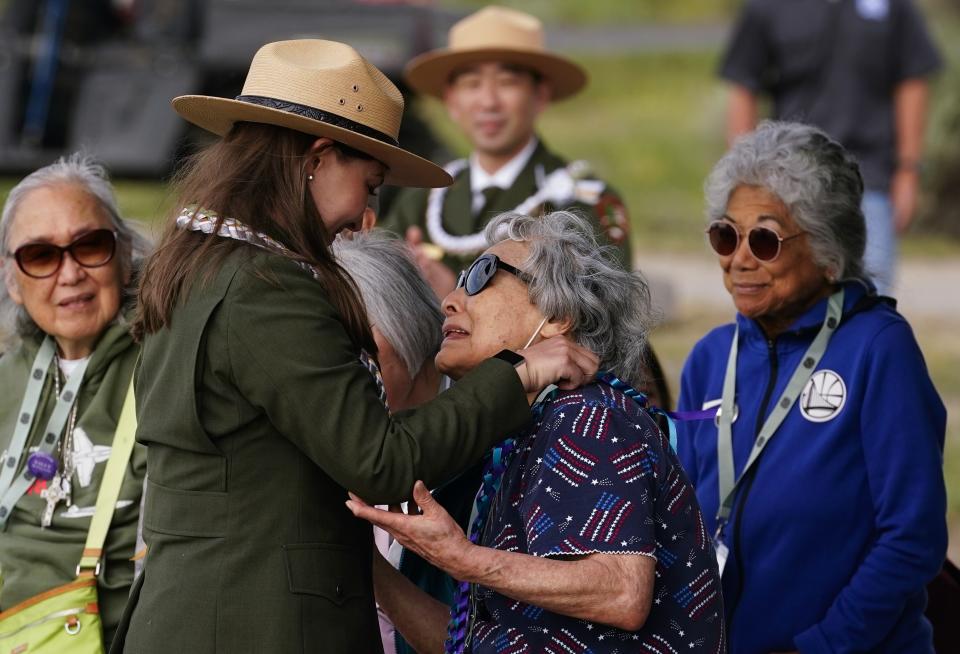 Minidoka survivor Fujiko Tamura Gardner, center, is honored with a wreath from her granddaughter, ranger Kelsea Holbrook, during a closing ceremony at Minidoka National Historic Site, Sunday, July 9, 2023, in Jerome, Idaho. (AP Photo/Lindsey Wasson)