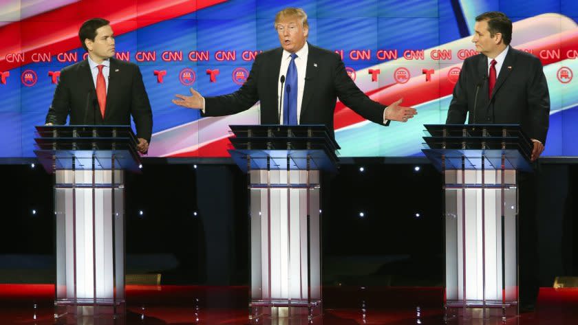 Marco Rubio, left, and Ted Cruz listen to Donald Trump as he answers a question during the CNN debate in Houston on Feb. 25.