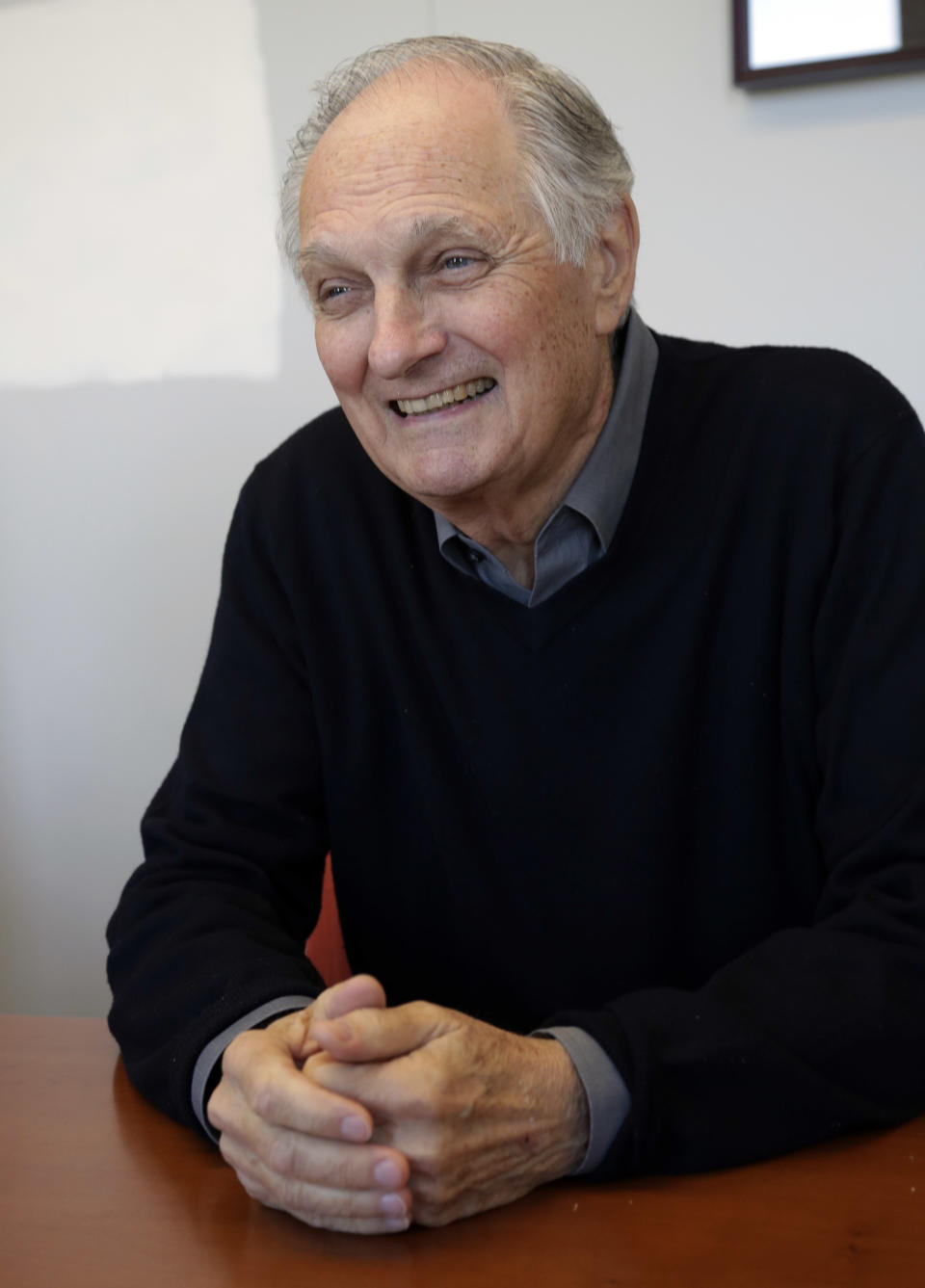 In this Friday, April 26, 2013 photo, actor Alan Alda speaks during an interview at Stony Brook University, on New York's Long Island. The film and television star is trying to encourage scientists of all disciplines to ditch the jargon and speak in plain English. (AP Photo/Richard Drew)