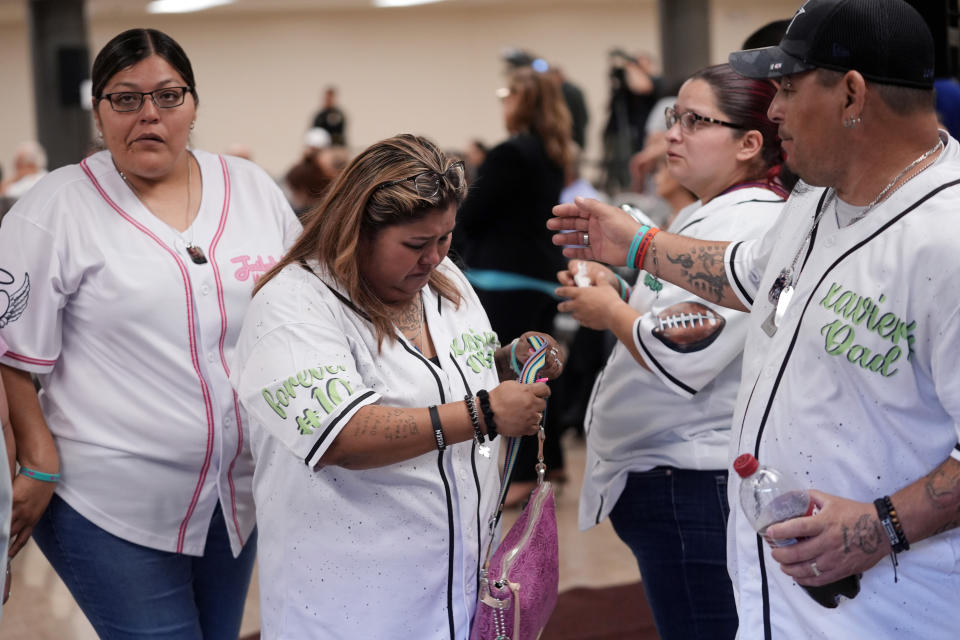 Felicia Martinez, center, and husband Abel Lopez, right, whose son Xavier was among 19 children killed in the massacre at Robb Elementary, depart a special city council meeting after speaking in Uvalde, Texas, Thursday, March 7, 2024. Almost two years after the deadly school shooting in Uvalde that left 19 children and two teachers dead, the city council met to discuss the results of an independent investigation it requested into the response by local police officers. (AP Photo/Eric Gay)