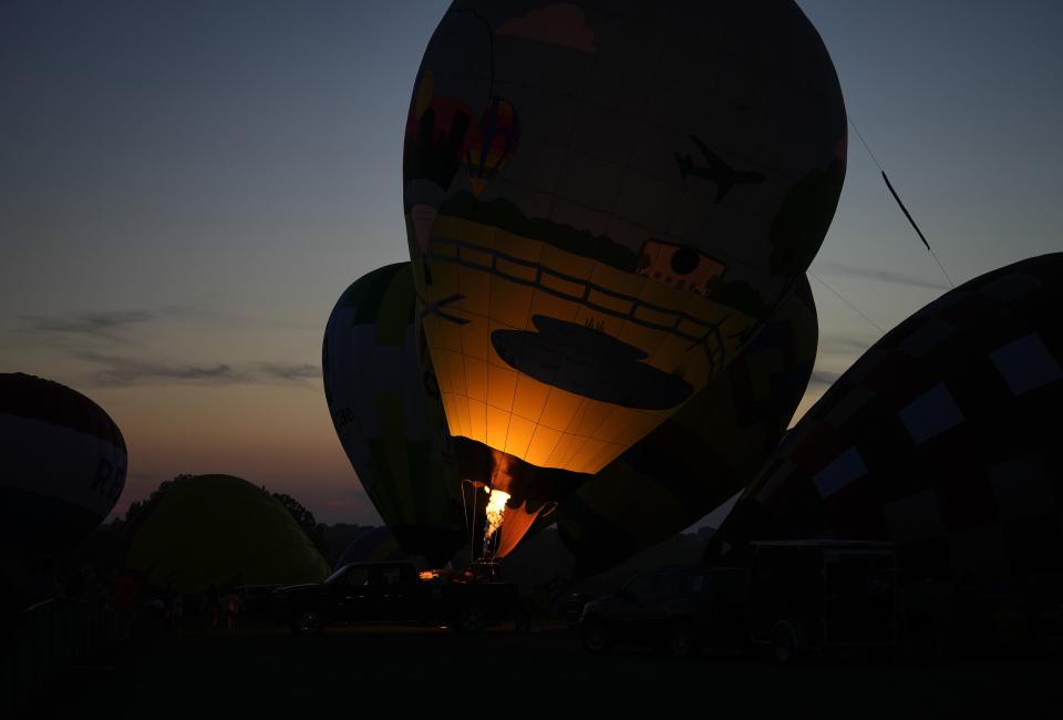 A hot air balloon glows during the night glow at the National Balloon Classic in Indianola, where Nia and Katie Chiaramonte once lived.