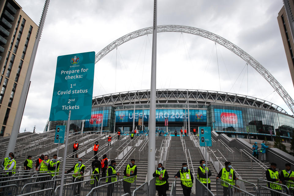 LONDON, ENGLAND - JULY 11: A general external view of Wembley with stewards and security manning the stairs behind Covid checks signage ahead of the UEFA Euro 2020 Championship Final between Italy and England at Wembley Stadium on July 11, 2021 in London, United Kingdom. (Photo by Robbie Jay Barratt - AMA/Getty Images)