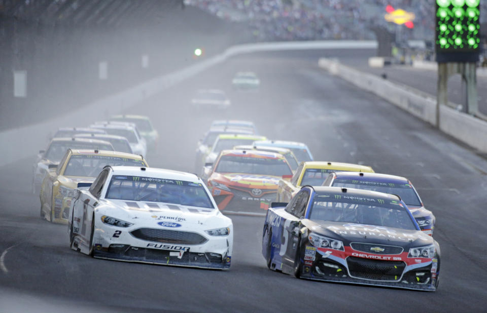 Kasey Kahne (5), right, takes the lead on the final restart as he heads into the first turn with Brad Keselowski (2) on his way to winning the NASCAR Brickyard 400 auto race at Indianapolis Motor Speedway, in Indianapolis Sunday, July 23, 2017. (AP Photo/AJ Mast)