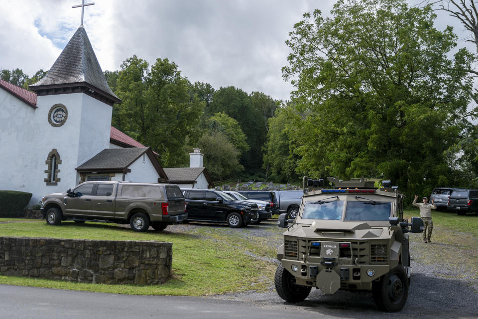 An armored vehicle parks in the lot next of the United Methodist Church in Nantmeal Village Monday, Sept.11, 2023 as the search for escaped convict Danelo Cavalcante continues in northern Chester County. This is is the area where his stolen van was located on Sunday. (Tom Gralish/The Philadelphia Inquirer via AP)