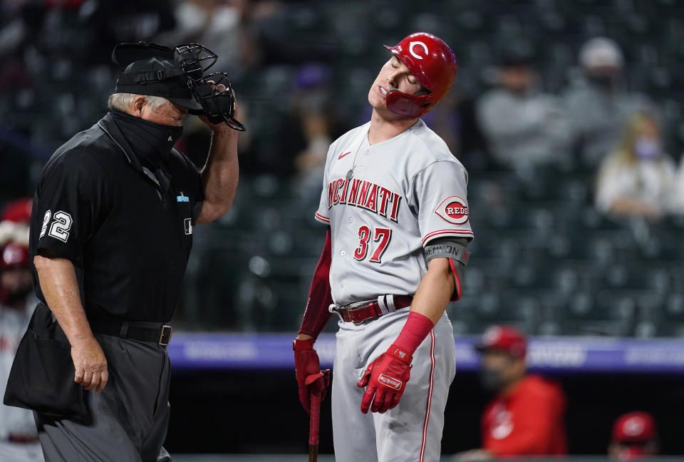 Cincinnati Reds' Tyler Stephenson reacts after he was called out on strikes on a check swing by home plate umpire Joe West while facing Colorado Rockies relief pitcher Mychal Givens during the eighth inning of a baseball game Thursday, May 13, 2021, in Denver. (AP Photo/David Zalubowski)