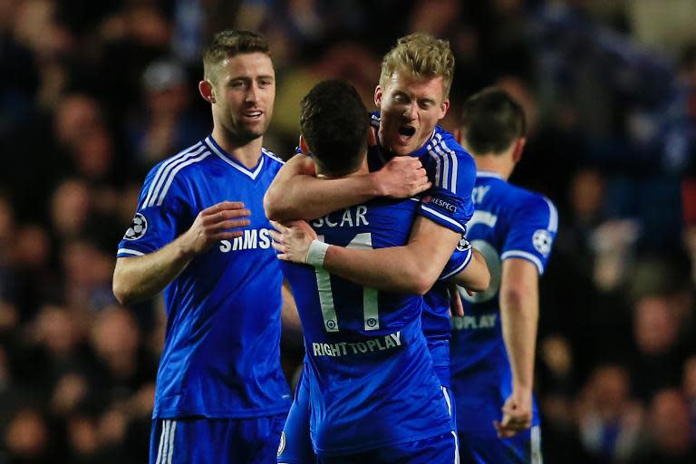 Chelsea's Andre Schurrle (R) embraces teammate Oscar after scoring a goal against PSG during their UEFA Champions League quarter-final second leg match, at Stamford Bridge in London, on April 8, 2014