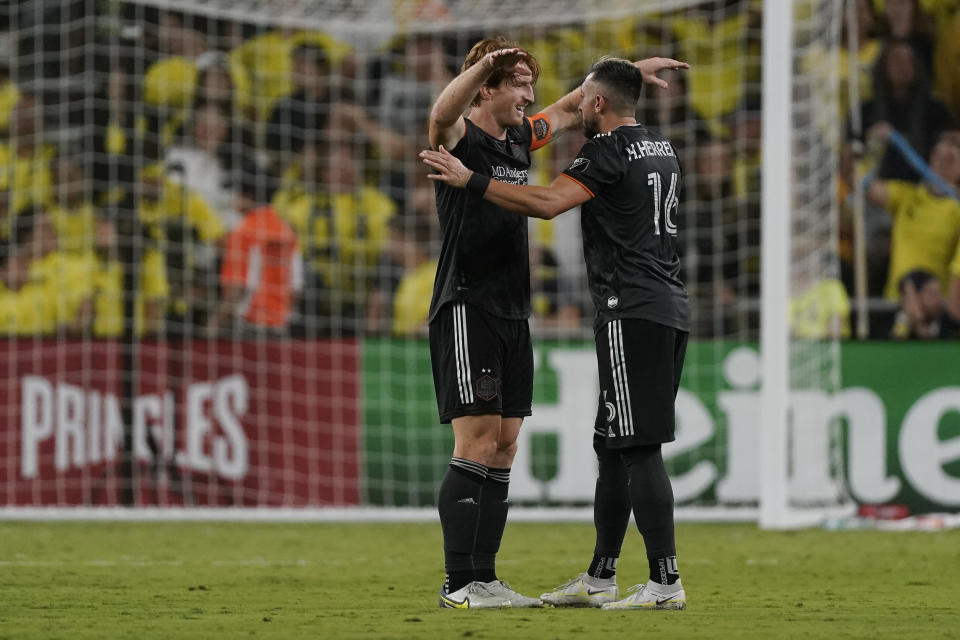 Houston Dynamo's Tim Parker, left, and Hector Herrera (16) celebrate their 2-1 win over Nashville SC in an MLS soccer match Sunday, Oct. 2, 2022, in Nashville, Tenn. (AP Photo/Mark Humphrey)