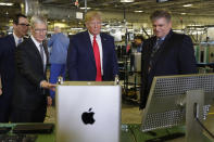 President Donald Trump tours an Apple manufacturing plant, Wednesday, Nov. 20, 2019, in Austin with Apple CEO Tim Cook, left. (AP Photo/ Evan Vucci)