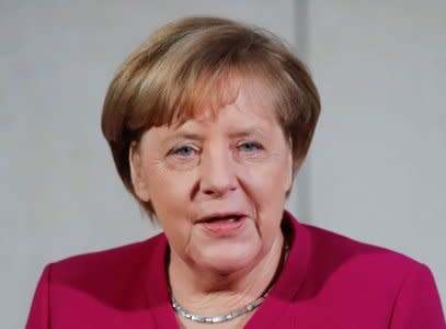 FILE PHOTO: Leader of the Christian Democratic Union (CDU) and the acting German Chancellor Angela Merkel delivers a speech before exploratory talks about forming a new coalition government at the SPD headquarters in Berlin, Germany, January 7, 2018. REUTERS/Hannibal Hanschke