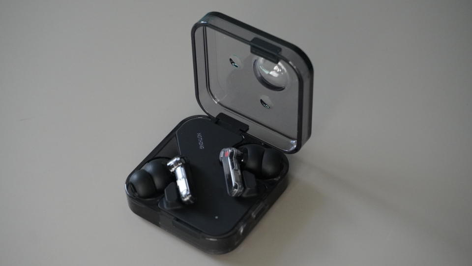 The Nothing Ear wireless earbuds in black on a grey background