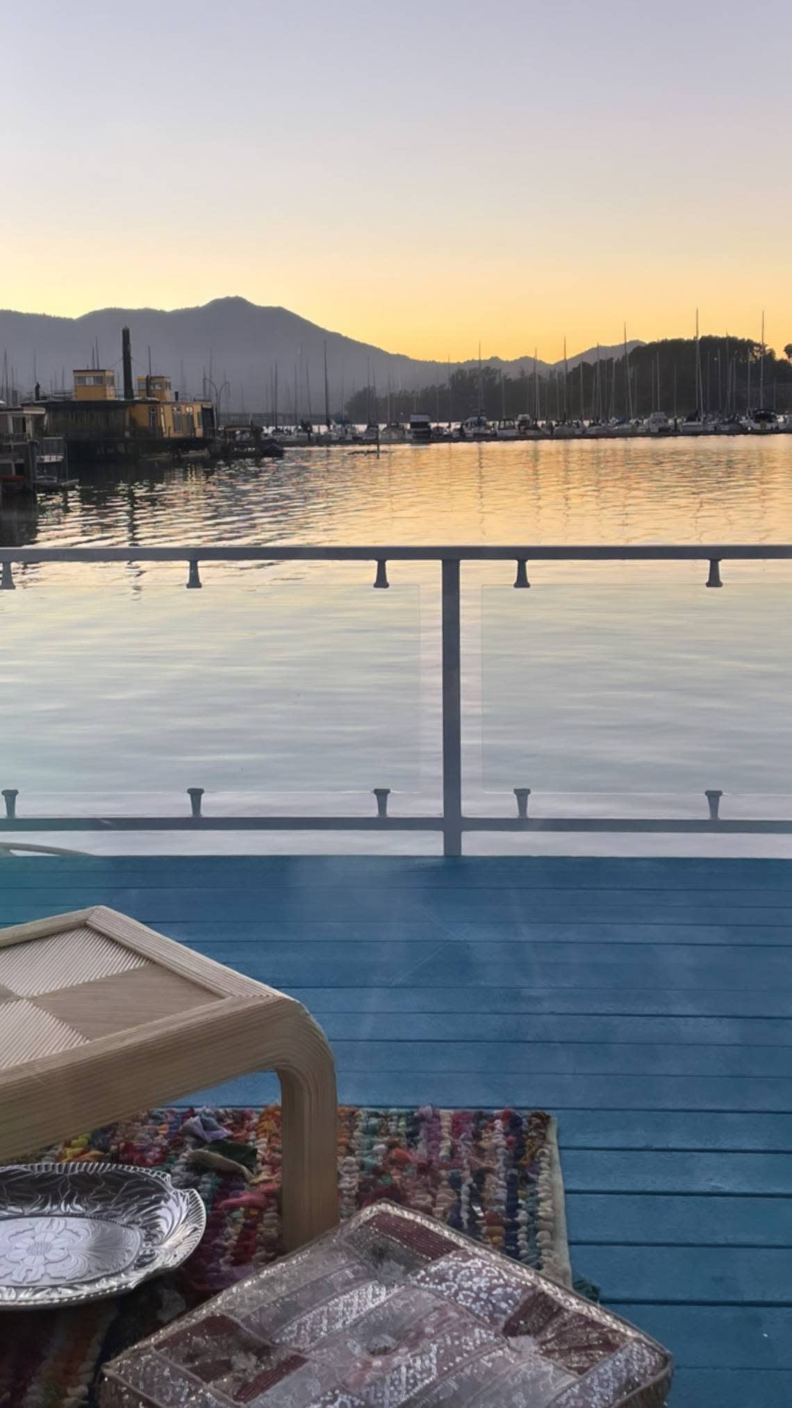 Sunset view of Richardson Bay, the marina, fellow houseboats and Mount Tamalpais (”Tam” in casual conversation) taken from the back deck of a houseboat in Sausalito, California.