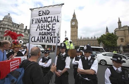 Demonstrators protest as Britain's Chancellor of the Exchequer George Osborne delivers his budget to the House of Commons, in London, Britain July 8, 2015. REUTERS/Paul Hackett