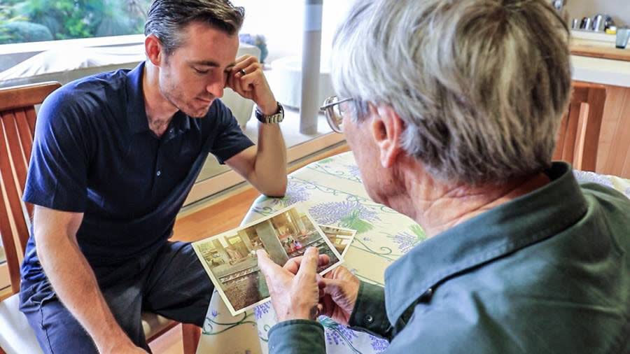 Dick Smith shows Chris Bray the photograph of the girl he wanted them to find. Photo: Facebook