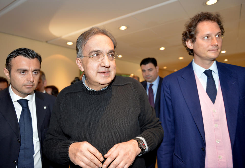 Fiat Chairman John Elkann, right, and Fiat and Chrysler CEO Sergio Marchionne arrive for a meeting with shareholders in Turin, Italy, Monday, March 31, 2014. Fiat and Chrysler CEO Sergio Marchionne says the combined automaker aims to sell 4.5 million to 4.6 million cars this year. Marchionne addressed the last Fiat shareholders' meeting on Monday at the Italian carmaker's historic headquarters in Turin, Italy. The CEO aims to complete the merger of Fiat with U.S. carmaker Chrysler this year to create Fiat Chrysler Automobiles, the seventh-largest automaker with 4.4 million sales last year. (AP Photo/Massimo Pinca)